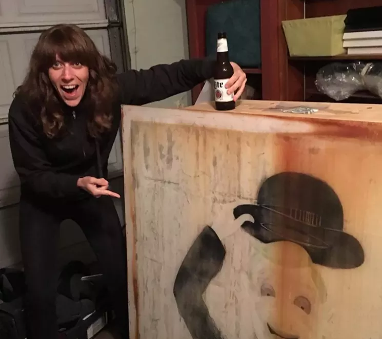 Elizabeth Mott "EMott" proudly showing off the old Howdy Doody sign that she got from the dumpster after it was replaced. - COURTESY OF JOEY LIECHTY