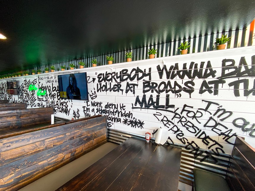 UKG and Jay-Z lyrics on the wall. - HANK VAUGHN