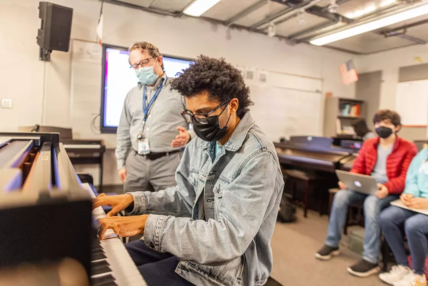 Piano and music theory instructor Leonardo Zuno Fernández offers performance advice to his student. - KATHY TRAN