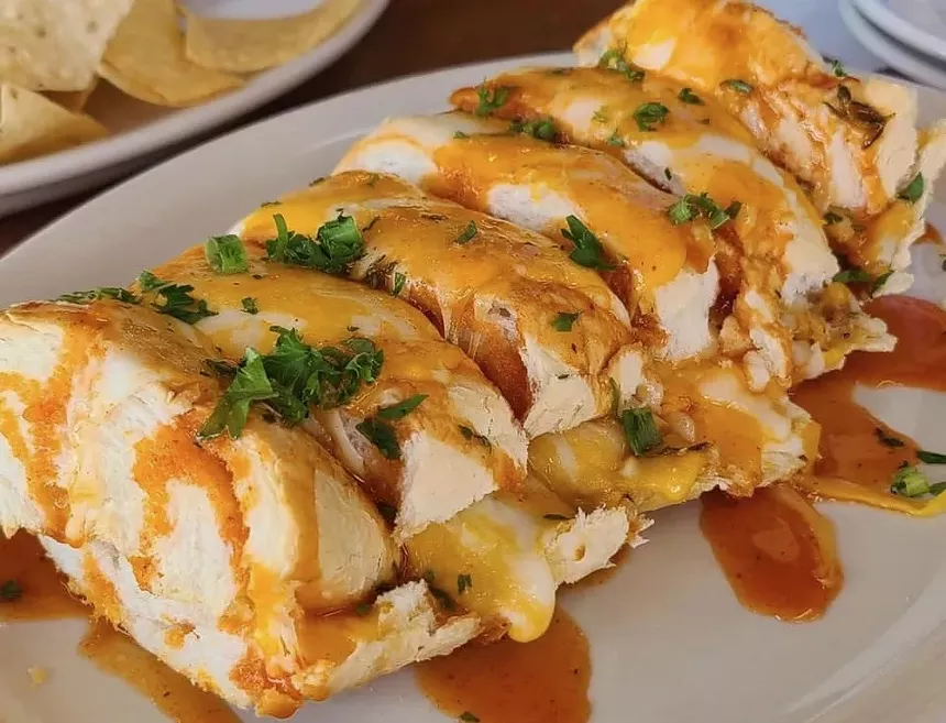Breaux Bread is stuffed with crab, crawfish, andouille sausage and cheese and topped with Crackfire sauce. - COURTESY OF BONGO BEAUX'S