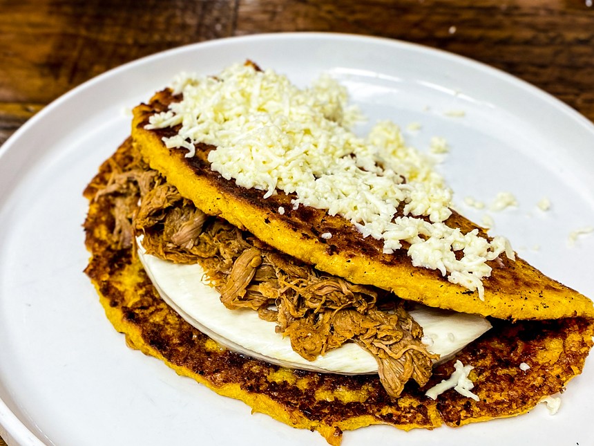 Cachapas: corn pancake filled with White shredded cheese and shredded beef and hand cheese - HANK VAUGHN
