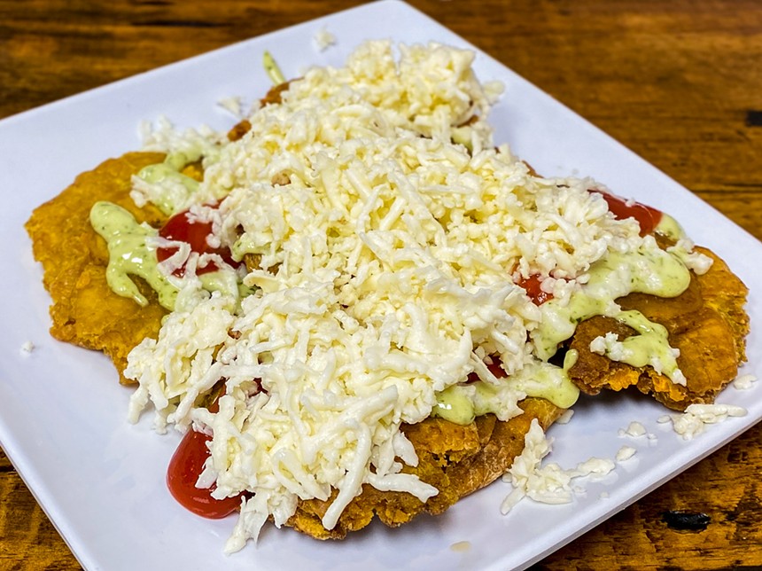 Tostones with cheese: fried plantains with shredded queso blanco and salsas - HANK VAUGHN