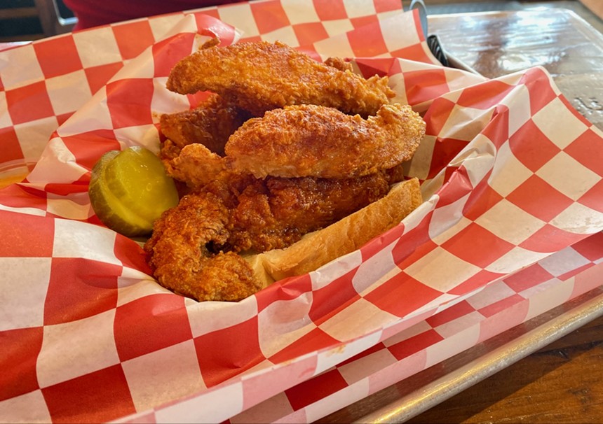 The chicken strips are served with pickles and a slice of white bread. - LAUREN DREWES DANIELS