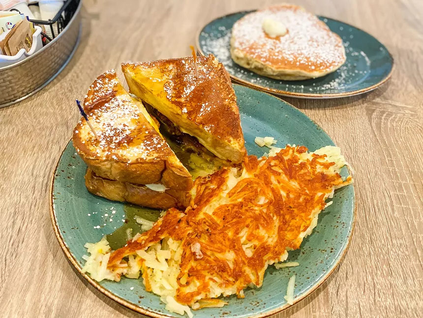 Back to bed sandwich - two easy eggs, ham, sausage, bacon and cheddar cheese drizzled with maple syrup and served on French toast as a bun - HANK VAUGHN