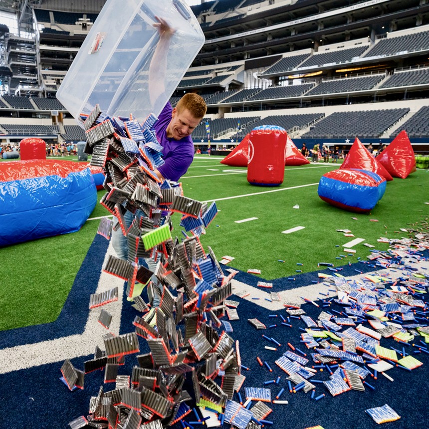 Blaster Battle event creator Jared Guynes dumps out a free batch of foam dart guns for Jared's Epic Blaster Battle 5 at AT&T Stadium. - MICHAEL CARIAGA PHOTOGRAPHY