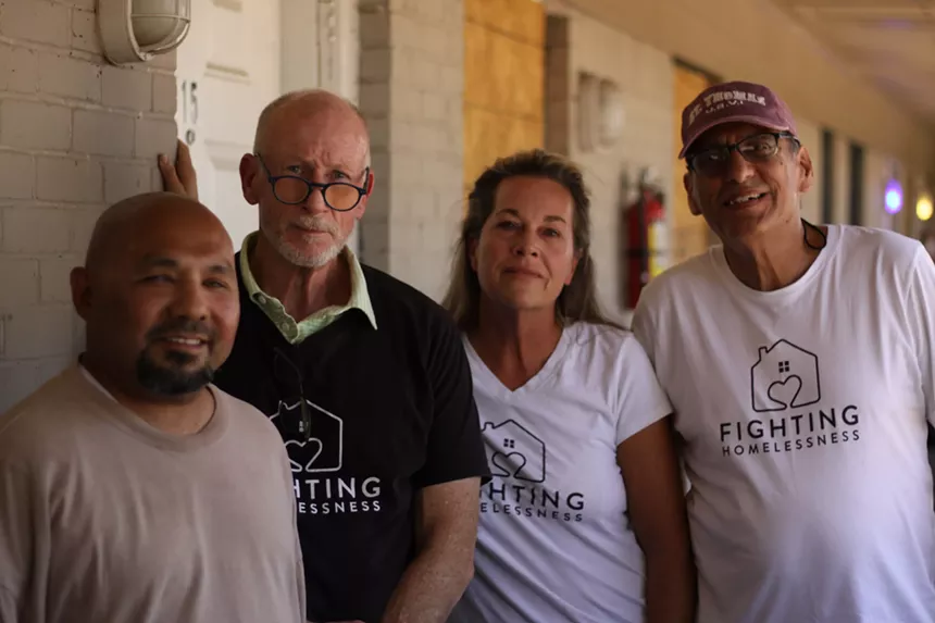 Members of Lisa Marshall's advocacy group, Fighting Homelessness, stand with her and Oakridge tenant Hector Hernandez outside his apartment. - JACOB VAUGHN