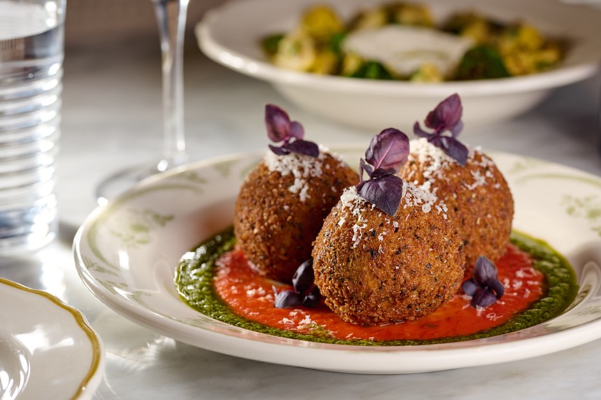Fried risotto balls served with marinara and herb sauce.