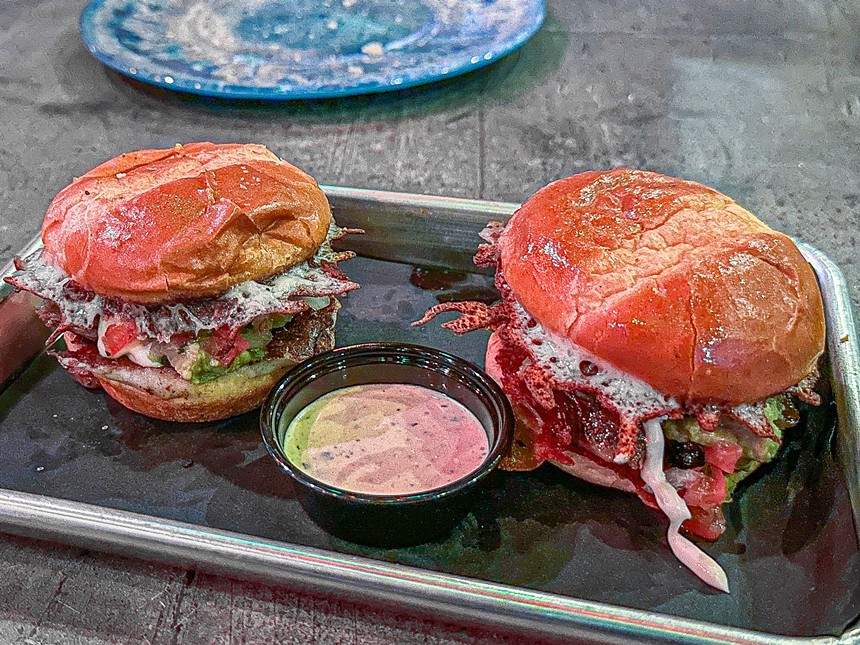 Tortinis are sliders, layered with guac, pico, mayo, melted cheese, and pork.