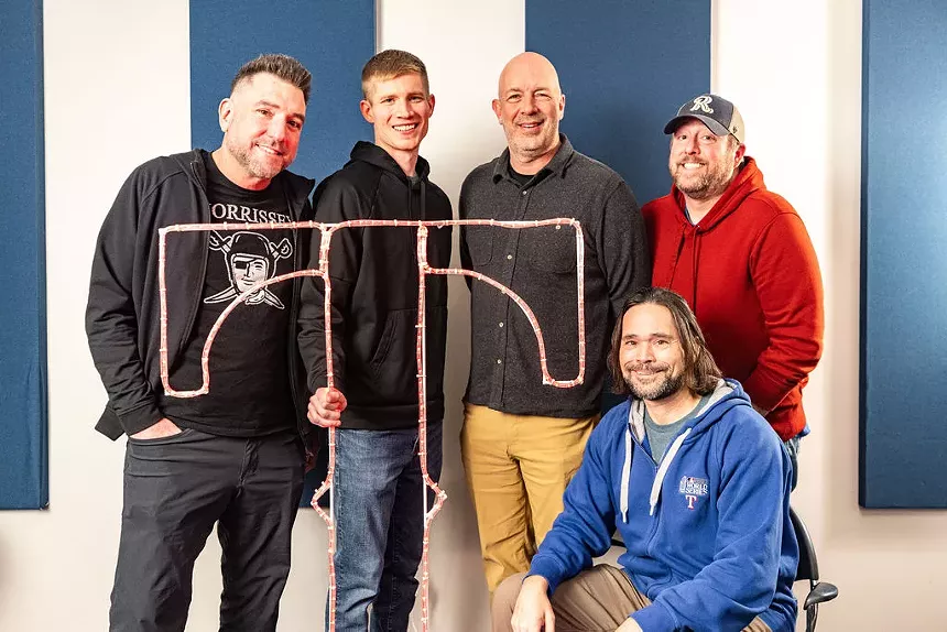 In addition to entertaining fans with sports/life talk, 1310 The Ticket's hosts do loads of appearances on behalf of charities.  From left to right: Dave Lane, David Mino, Bob Sturm, Sean Bass and Corby Davidson (seated).