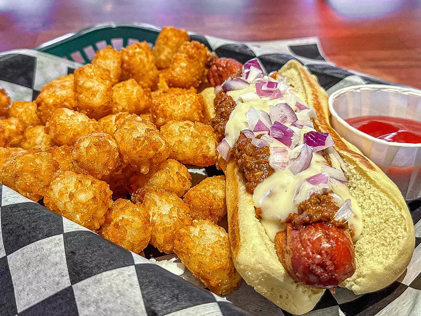 The Texas Dawg with chili and queso and a side of tots.