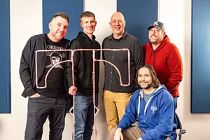 In addition to entertaining fans with sports/life talk, 1310 The Ticket's hosts do loads of appearances on behalf of charities. From left: Dave Lane, David Mino, Bob Sturm, Sean Bass and Corby Davidson (seated).