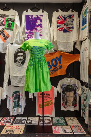 Items on display at a Dallas punk exhibition, including clothing.