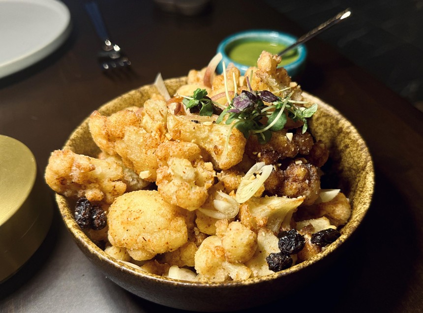 Fried cauliflower with goat cheese and raisins.