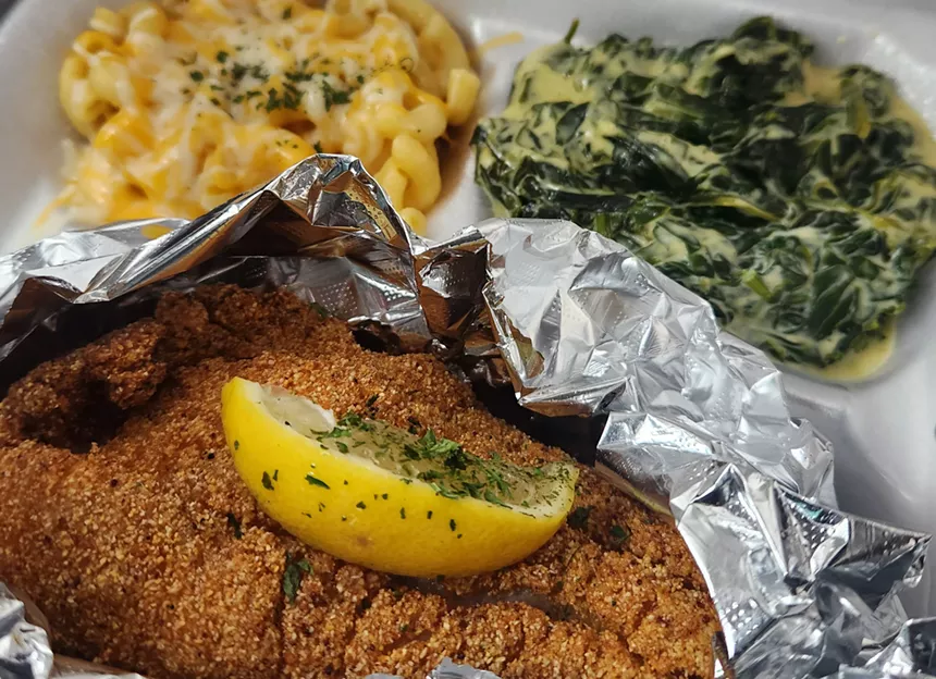 a plate of catfish, greens and macaroni