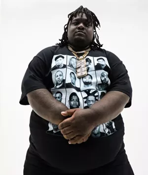 Man standing with gold chains