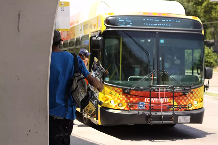 Riders board a DART bus.