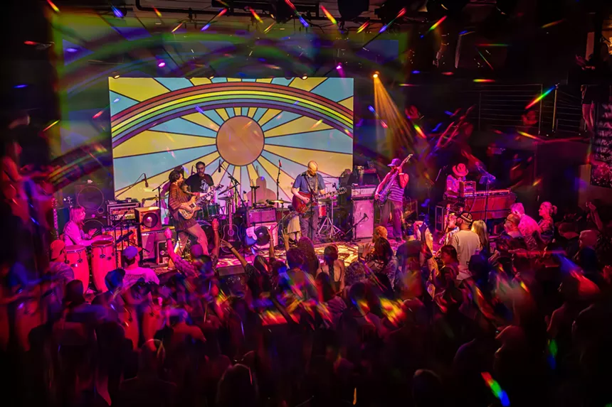 A group of musicians and band members on stage