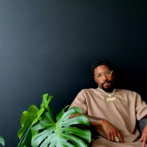 Man sitting next to a plant