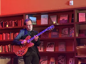 Man playing guitar on stage