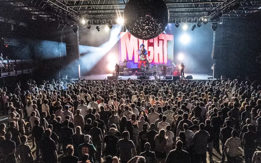 A crowd watching a band on stage