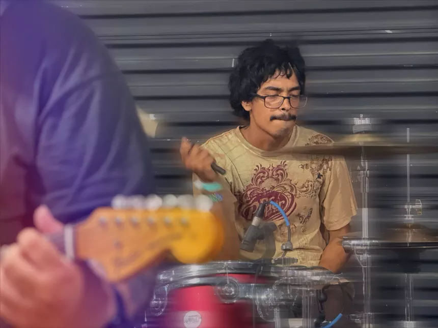 Man drumming on stage