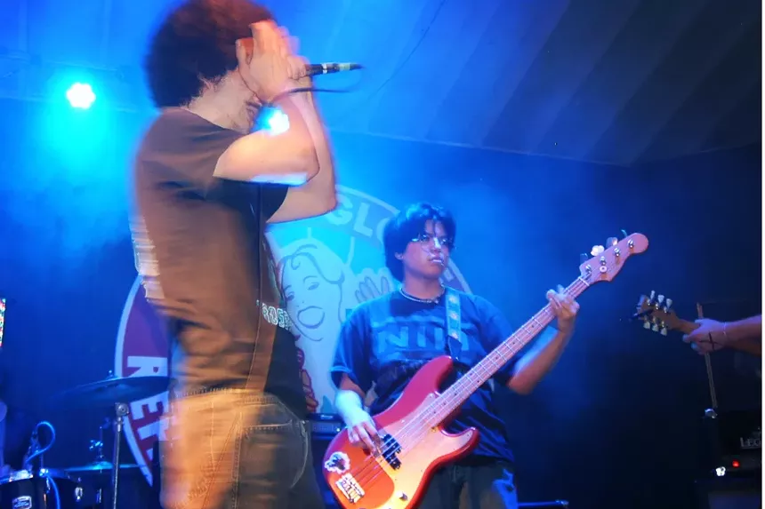 Three guys performing on stage