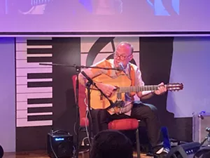 Man playing guitar on stage