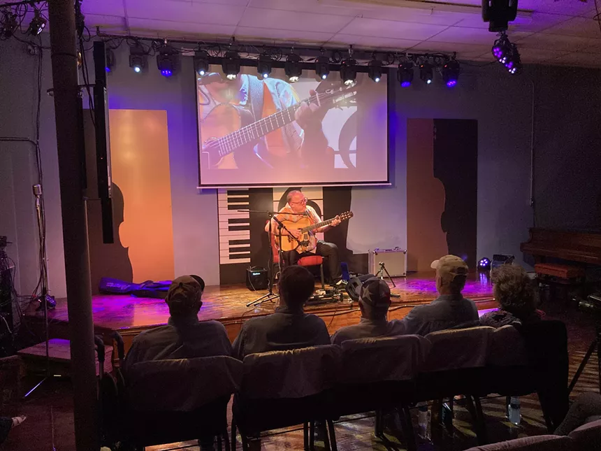 Man playing guitar on stage