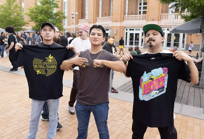 Fans holding merch