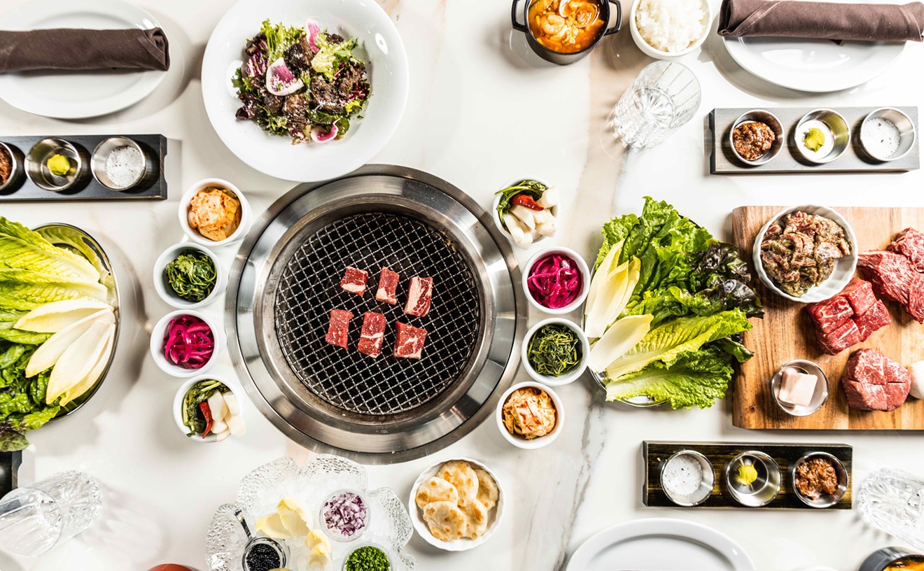 A grill is the center of each table, creating a community experience.