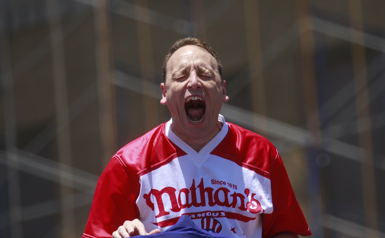 Competitive eater Joey Chestnut didn't miss a beat and kept eating a hotdog while confronted by a protestor.