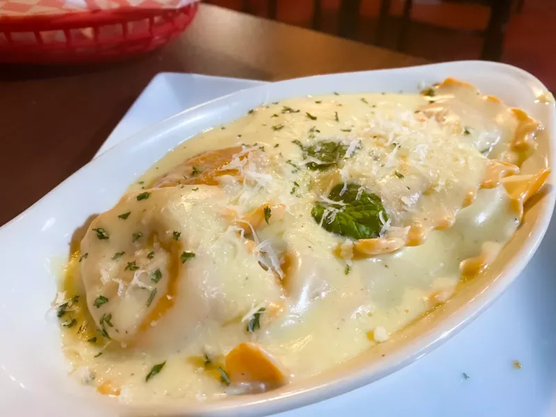 Seasonal butternut squash ravioli with alfredo sauce.