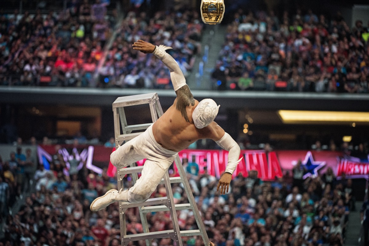 Sin Cara takes a tumble from the top rung during a preliminary ladder match at Wrestlemania 32 at AT&T Stadium.