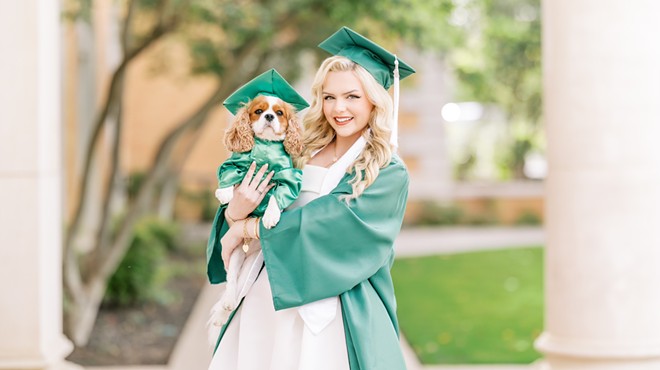 Lauren Clark and her dog Holly pose for Clark's graduation photos.