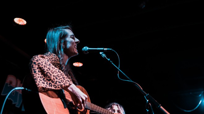 Dallas singer Sarah Johnson plays guitar onstage.