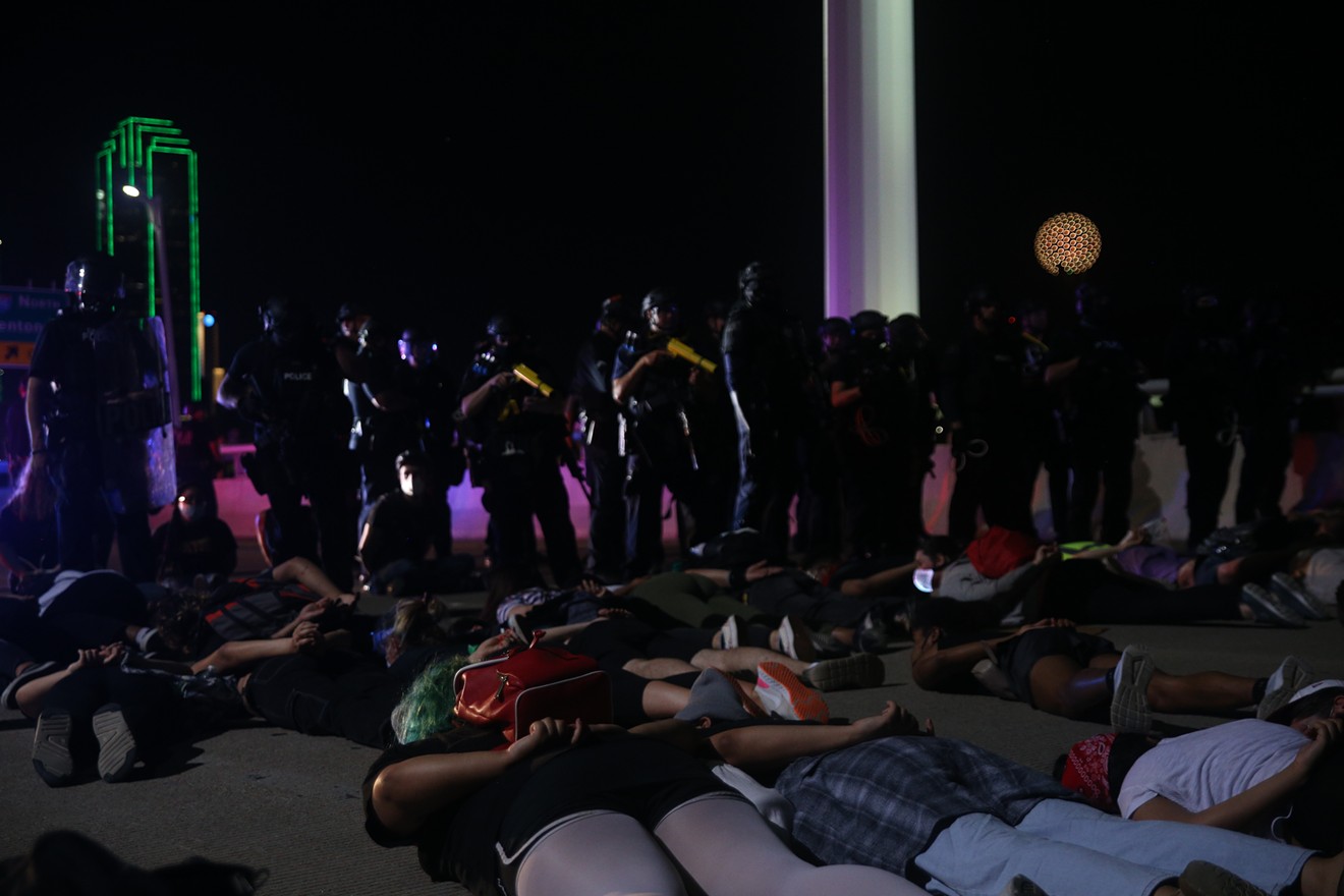 Protesters lie on their stomachs waiting to be detained by police after marching on the Margaret Hunt Hill Bridge June 1.