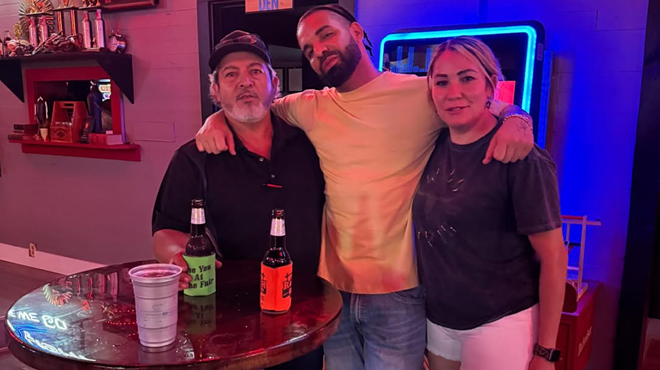 Man posing with fans