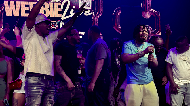 A picture of a rapper on stage